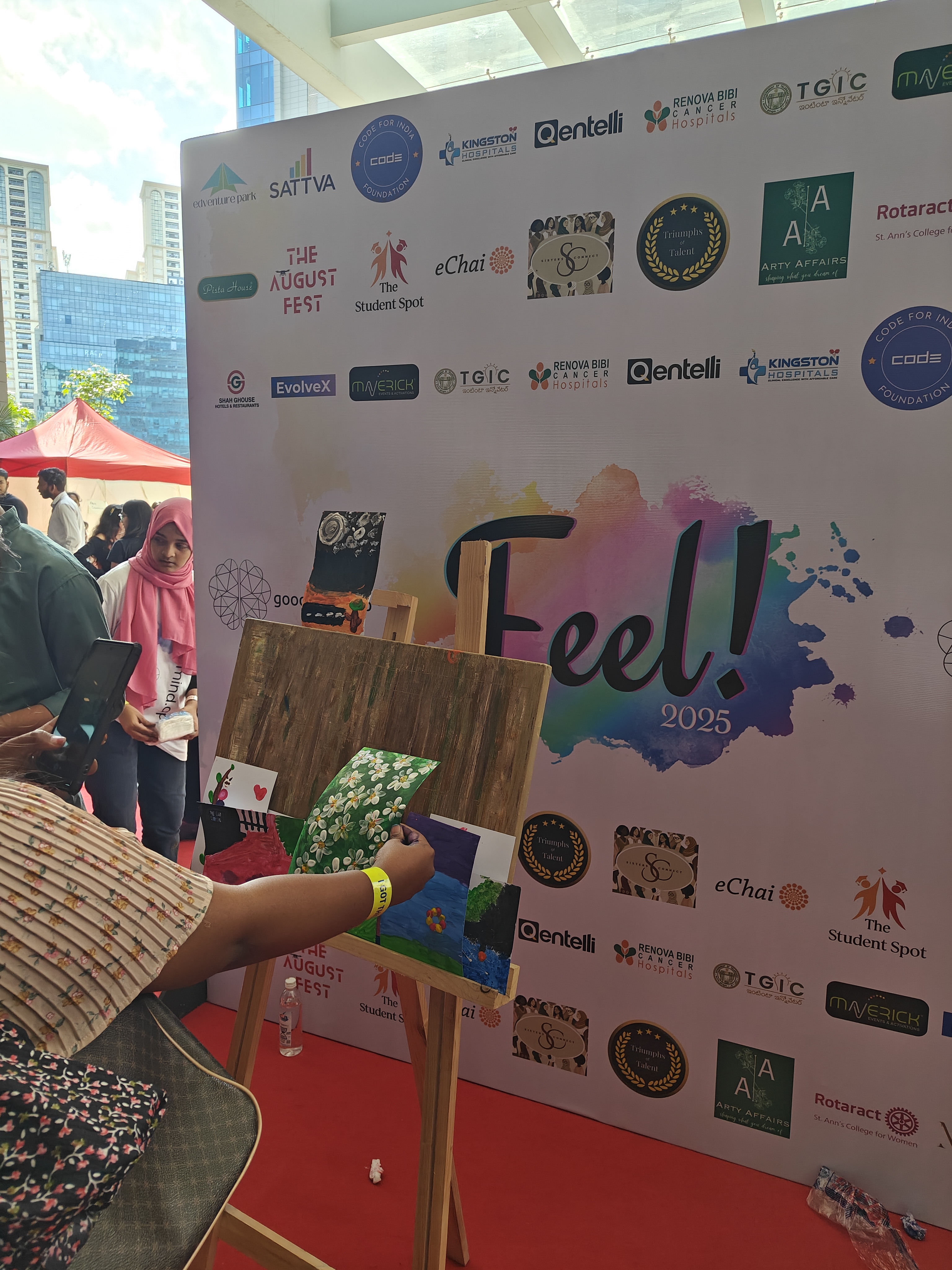 A visitor finger painting at the FEEL art corner